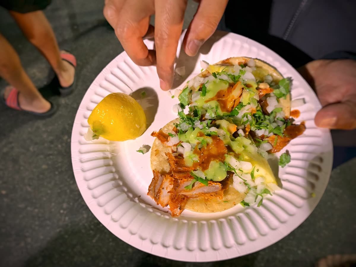 Tacos al pastor recién servidos con piña y cilantro